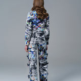 Bold abstract print top with front bow detail and structured fit. A modern, artistic statement piece.