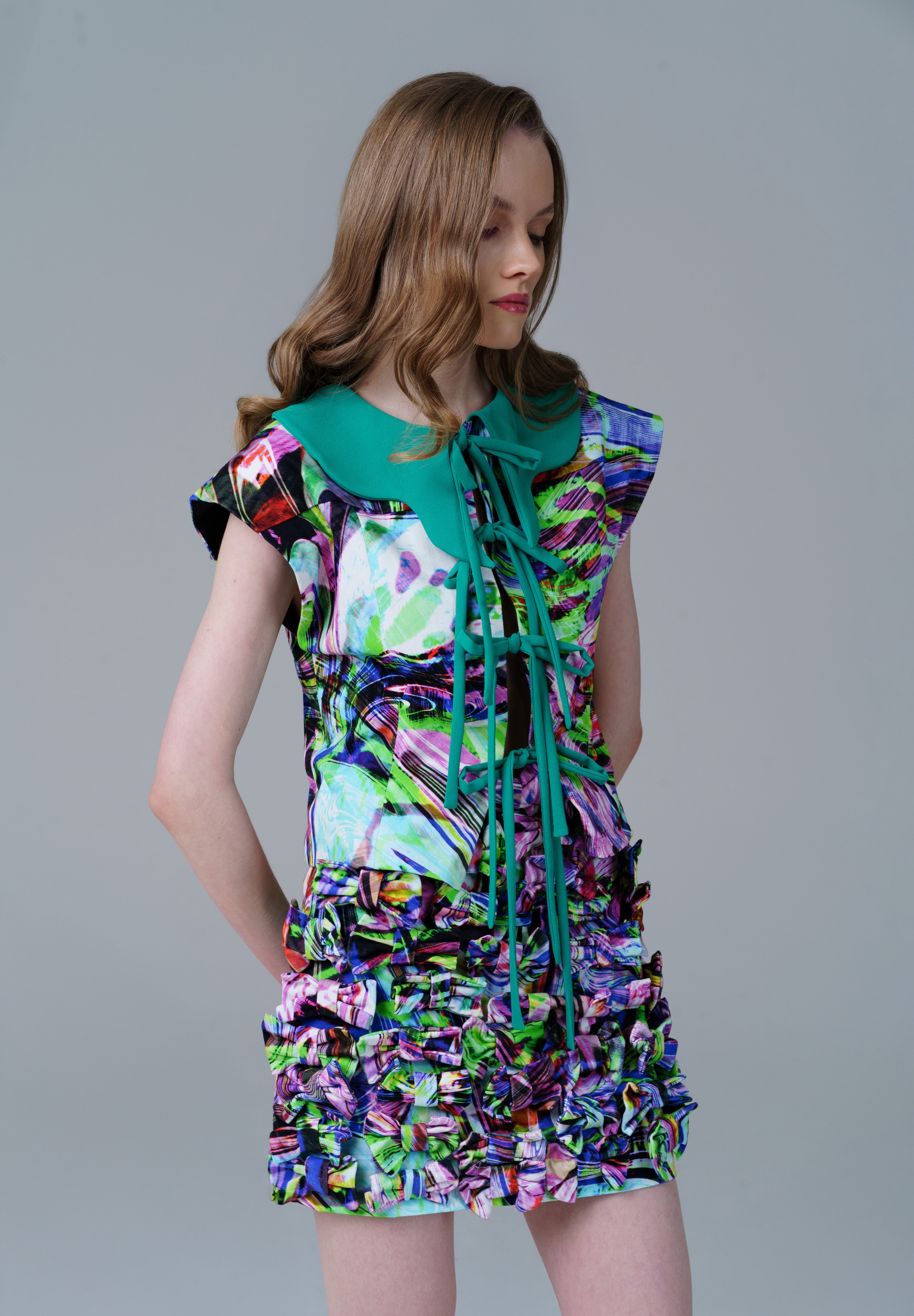 Collar Shirt with psychedelic print and tie up neckline, framed by green accents