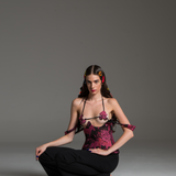 Bra with dark pink floral patterns on a black base and monstera-shaped cutouts.