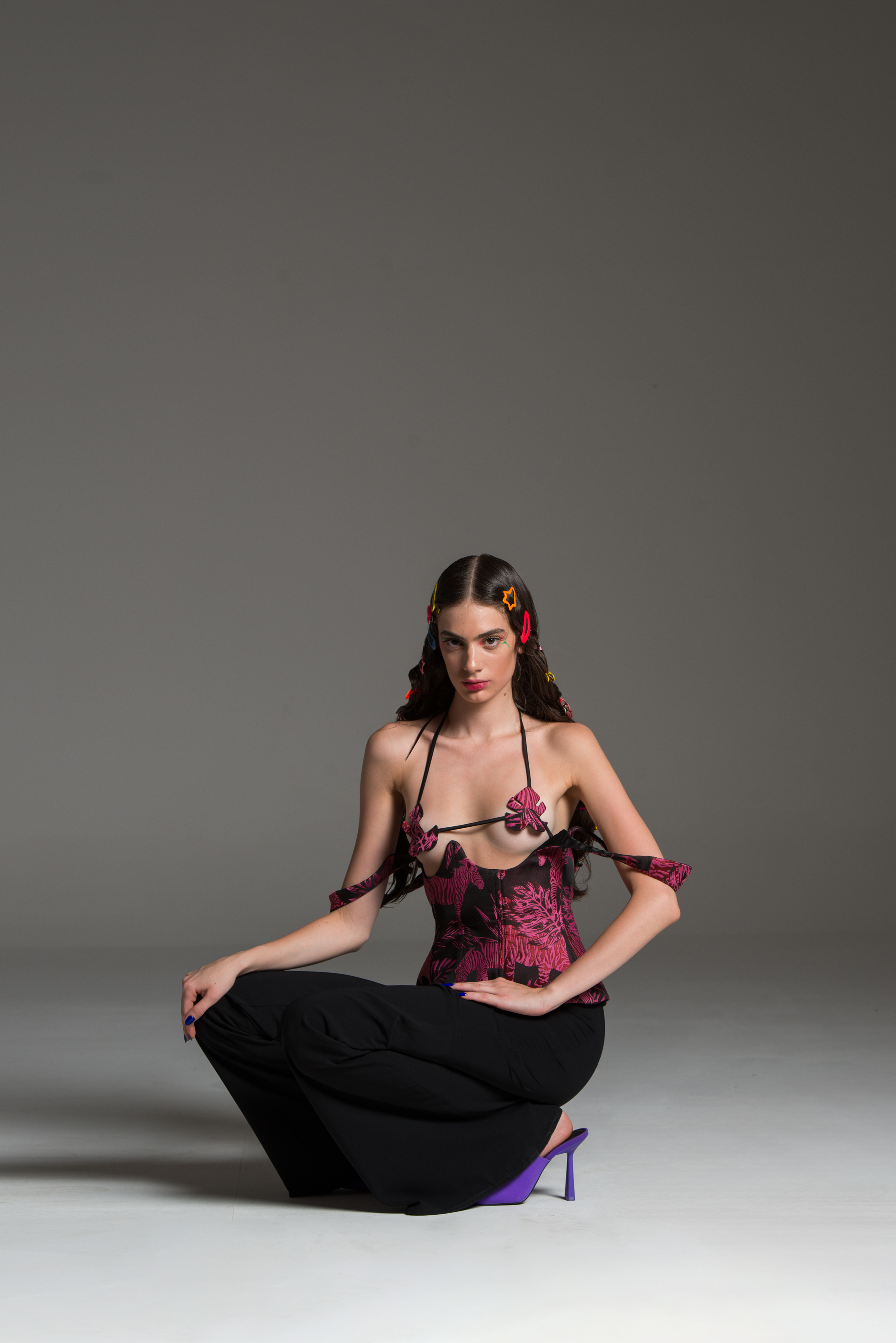 Bra with dark pink floral patterns on a black base and monstera-shaped cutouts.